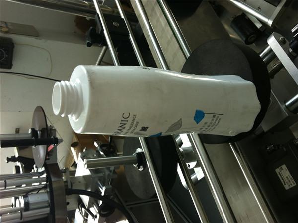 Sistema d’etiquetatge envoltant orientat per a ampolla rodona / contenidor / pot